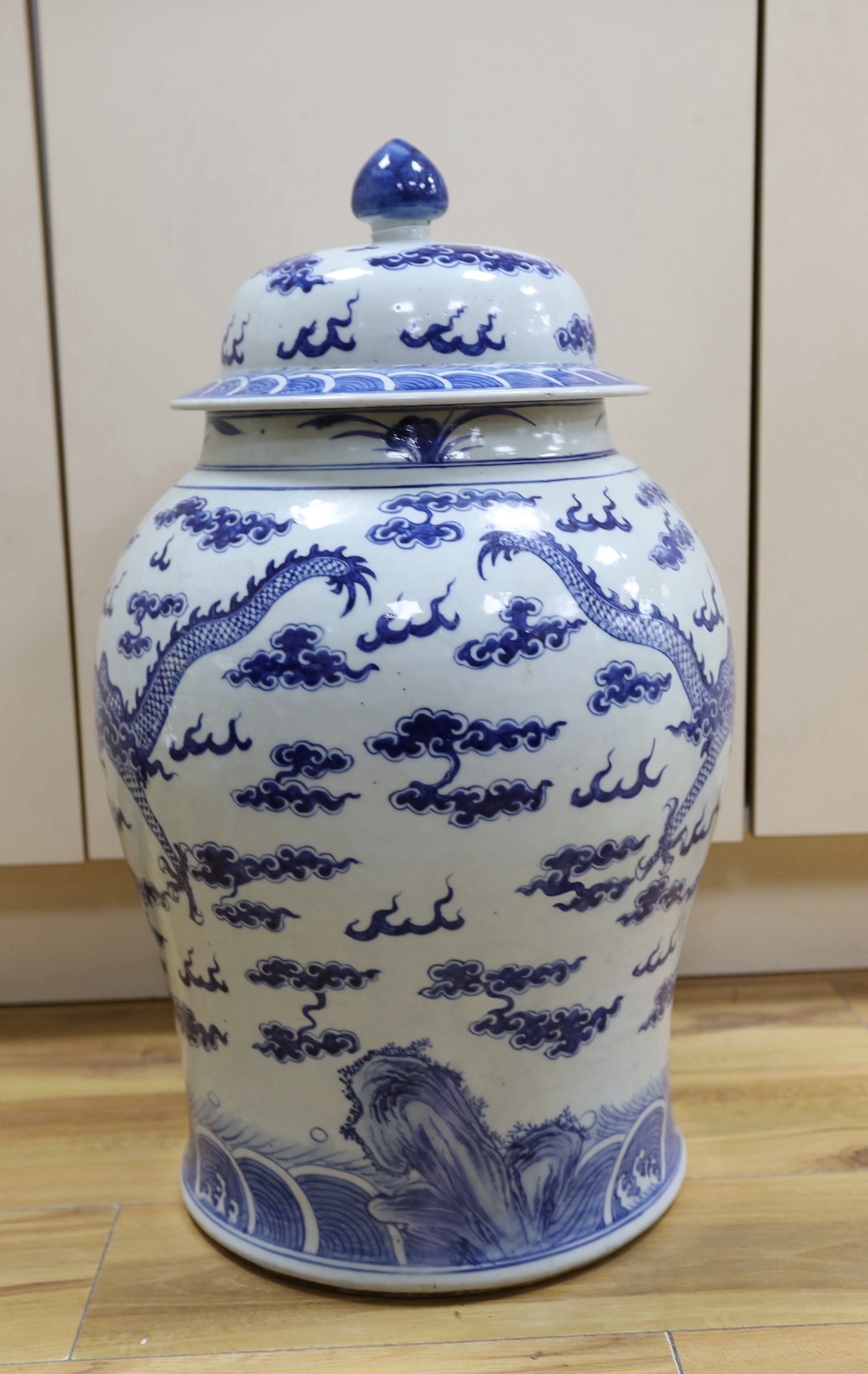 A 19th century Chinese large blue and white 'dragon' jar and cover, 63cms high